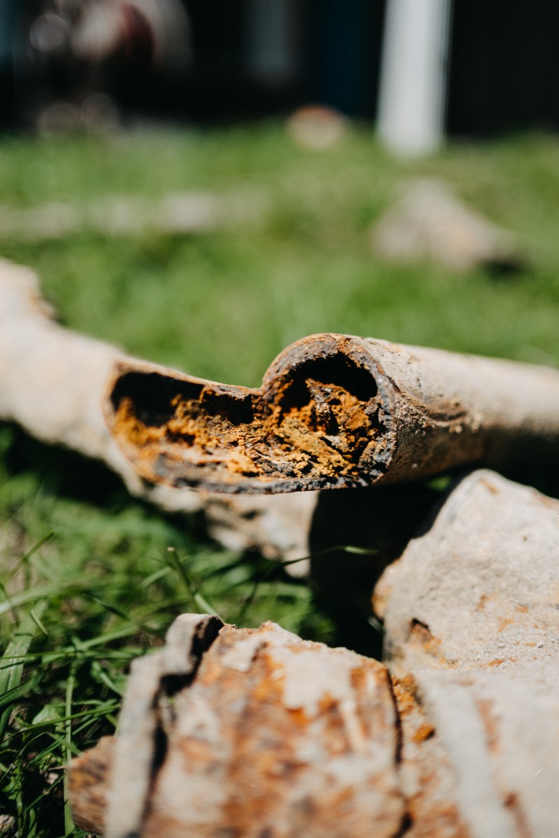 Corroded sewer pipe destroyed by tree root intrusion, removed from a Central Arkansas yard