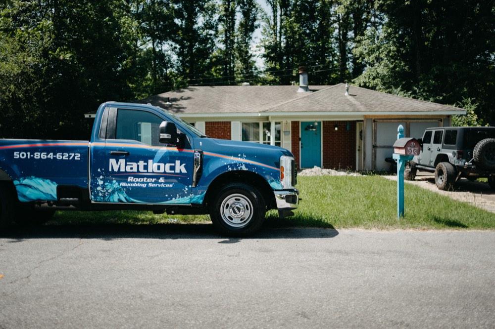 Matlock Rooter Services truck parked in front of a Central Arkansas home