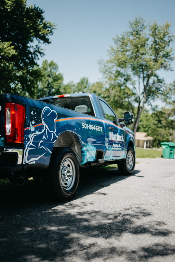 Water-themed wrap detail on a Matlock Rooter Services truck