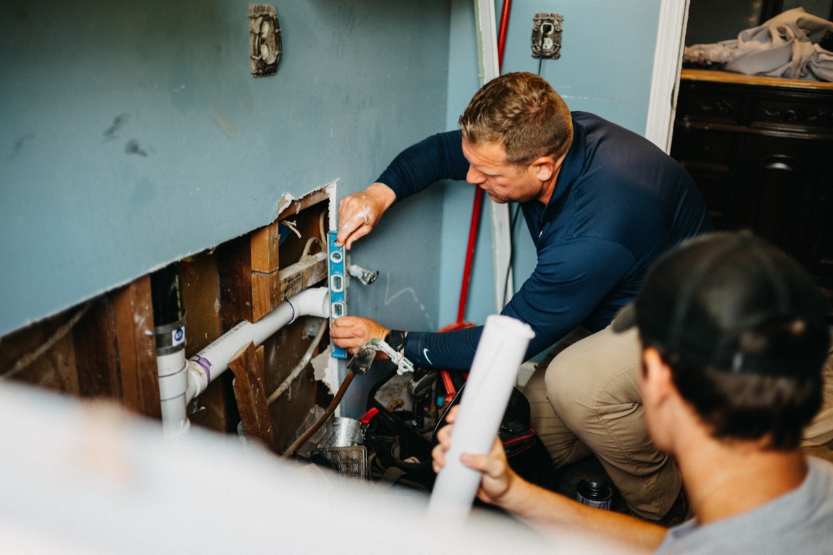 Matlock Rooter Services technicians collaborating on an interior plumbing repair