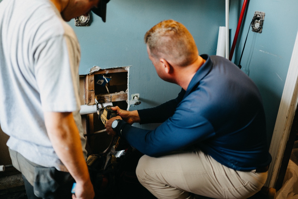 Matlock Rooter Services technicians working on plumbing inside a Sherwood area home